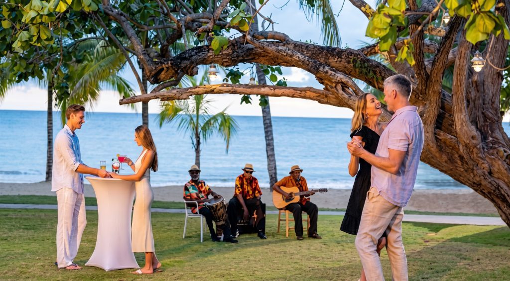 Couple Toast with Guitarist by Jamaican Beach